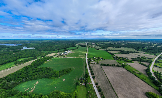 Drone shot of lush green fields near the village of Prairie du Sac in Sauk County, Wisconsin on a sunny day in summer.