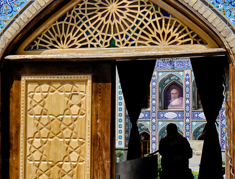 Tehran (Teheran) , Iran-June 25, 2023: Tehran (Teheran), Iran 06.25.2023: Emamzadeh Saleh mosqeu entrange gate and imam  khomeini photo background.