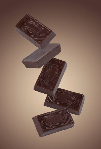 istock dark chocolate candies flying on a beige background, mockup 1905147186
