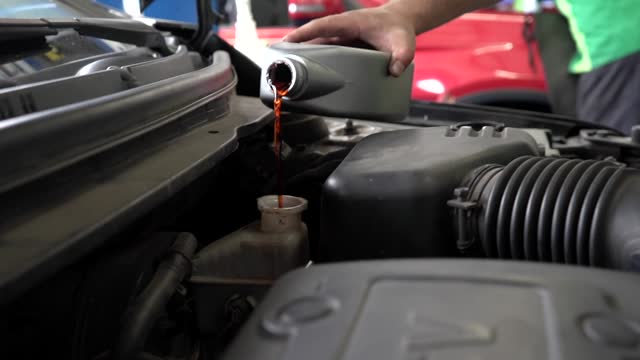 Close up footage of a Maintenance Car service - auto oil change, motor check, brake cleaning, tire check, engine inspection, motor oil-brake inspection