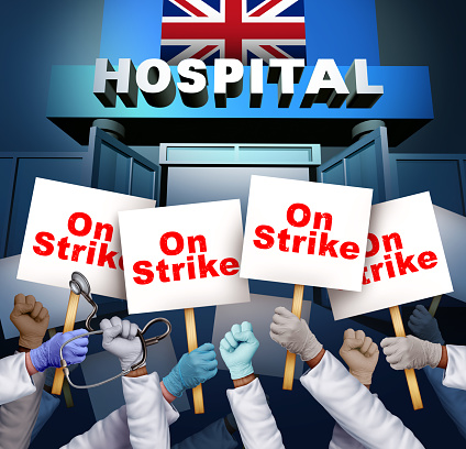 UK Hospital Workers On Strike and England Health Service Strike or Health-Care Workers Striking as Doctor or medical staff picketing and a Hospital worker group at a picket line striking.