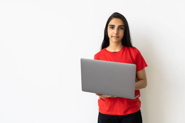 istock Indian woman using laptop on white background. 1905183818