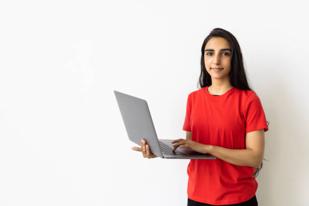 istock Indian woman using laptop on white background. 1905192456