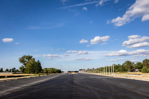 istock Highway construction. The process of building a highway. Construction site with construction equipment tools and machines used in road construction 1905218554