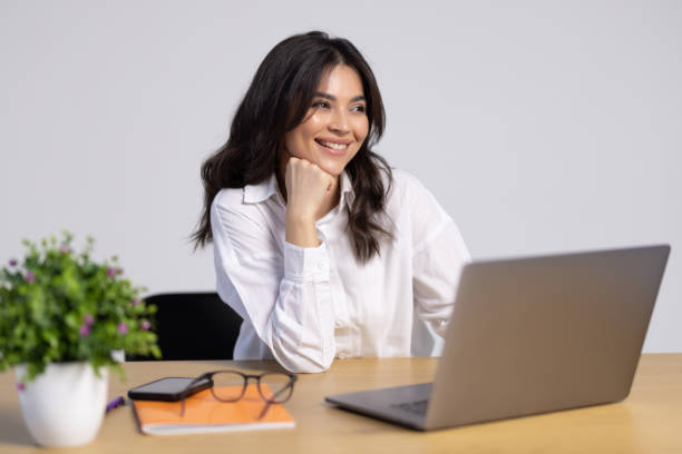 istock Confident businesswoman working on laptop at her workplace at modern office. 1905243629