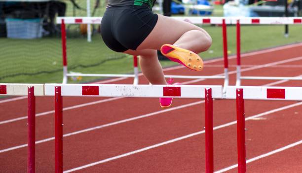 istock Woman Clearing a Hurdle on a Track during a race 1905248262