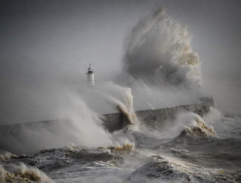 Raging storm and winds at the lighthouse and harbour on the English south coast at Newhaven. UK