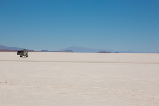 Jeep on Salar de Uyuni, Bolivia. Largest salt flat in the world. Bolivian landscape