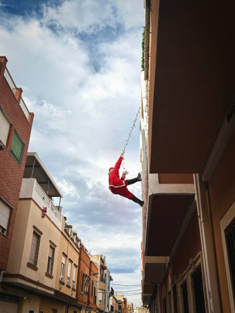 santa claus doll climbing up a facade