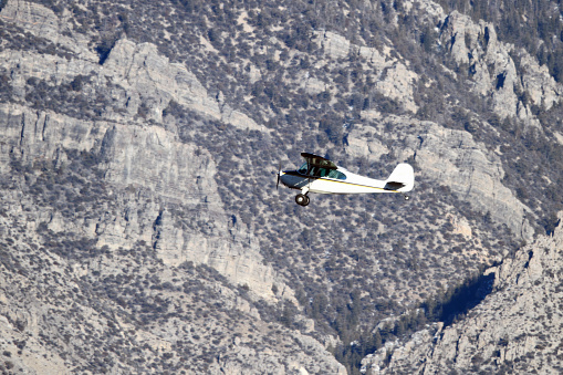 Private Airplane (Aronca 7AC) flying through the mountains of East Central Idaho.