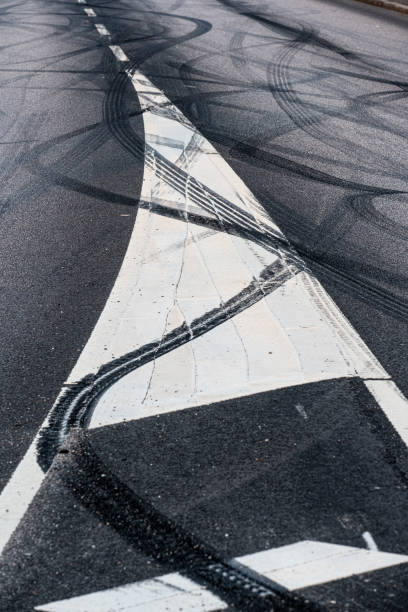 istock Black rubber tire marks in a street.. 1905349399