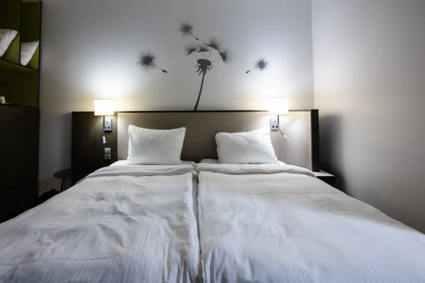 istock Hotel bed in a small room.. 1905356151