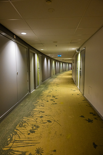 Long hotel corridor with a bend.