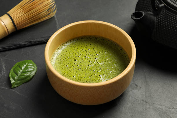 istock Cup of fresh matcha tea on black table, closeup 1905383042