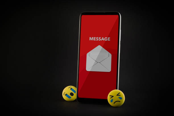 istock Emoji face and smartphone on black background. Emoticon concept. 1905396977