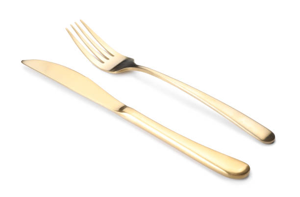 istock Shiny golden fork and knife isolated on white. Luxury cutlery 1905411955