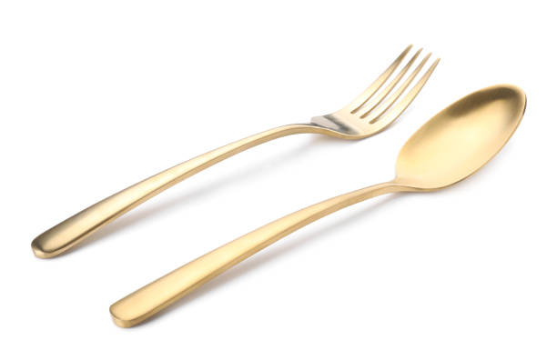 istock Shiny golden fork and spoon isolated on white. Luxury cutlery 1905412467