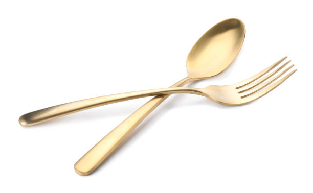 istock Shiny golden fork and spoon isolated on white. Luxury cutlery 1905412470