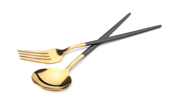 istock Shiny golden fork and spoon isolated on white. Luxury cutlery 1905412998