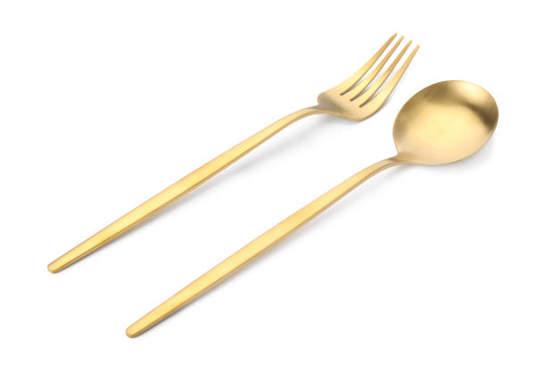 istock Shiny golden fork and spoon isolated on white. Luxury cutlery 1905413000