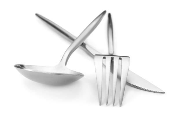 istock Shiny silver fork, knife and spoon isolated on white. Luxury cutlery set 1905413511