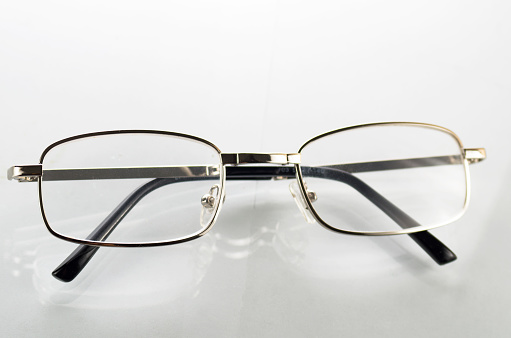 Glasses with metal frames on a white background