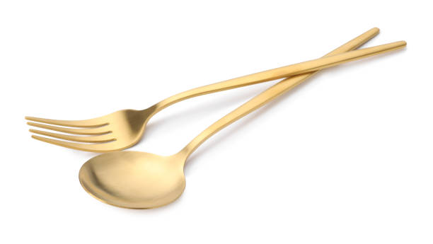 istock Shiny golden fork and spoon isolated on white. Luxury cutlery 1905414528