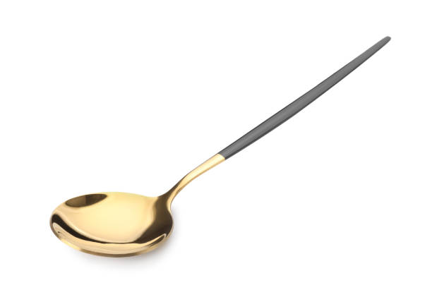 istock One shiny golden spoon with black handle isolated on white 1905414564
