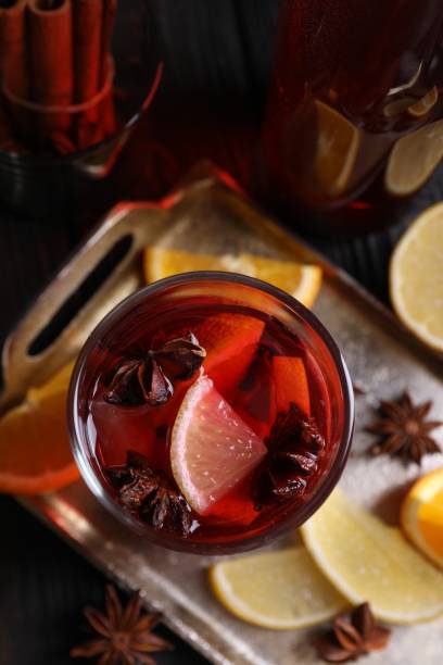 istock Glass of aromatic punch drink and ingredients on table, flat lay 1905461913