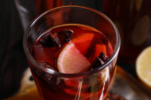 istock Glass of aromatic punch drink on table, closeup 1905463974