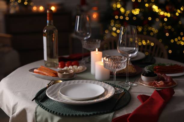 istock Christmas table setting with burning candles, appetizers and dishware indoors 1905489294