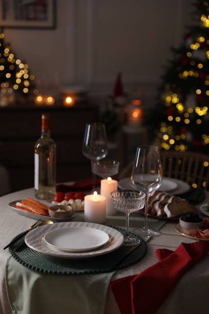 istock Christmas table setting with burning candles, appetizers and dishware indoors 1905489801