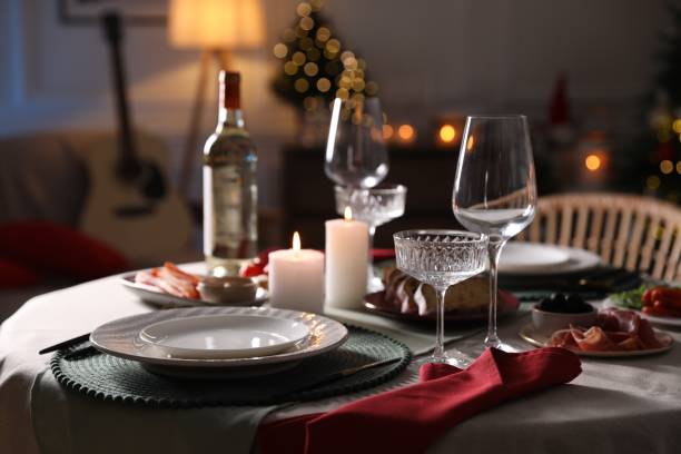 istock Christmas table setting with burning candles, appetizers and dishware indoors 1905490865