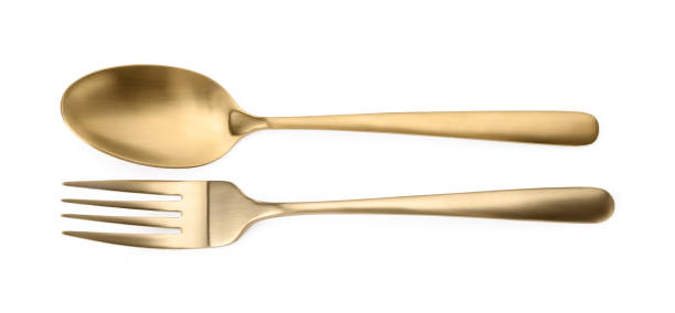 istock Shiny golden fork and spoon isolated on white, top view. Luxury cutlery 1905491373