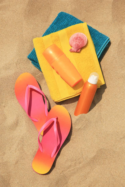 istock Flat lay composition with sunscreens on sand. Sun protection care 1905517259