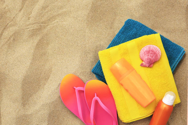 istock Flat lay composition with sunscreens on sand, space for text. Sun protection care 1905517265