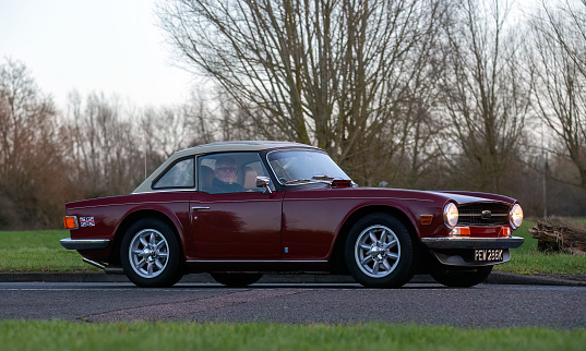 Stony Stratford,UK Jan 1st 2024. 1971 red Triumph TR6 sports car arriving at Stony Stratford for the annual New Years Day vintage and classic vehicle festival.