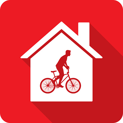 Vector illustration of a house with man riding bicycle against a red background in flat style.