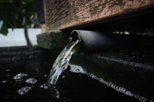 istock Water is flowing through  a small pipe above the pond 1905651907