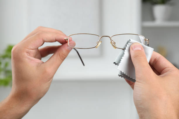 istock Man wiping glasses with microfiber cloth indoors, closeup 1905658811