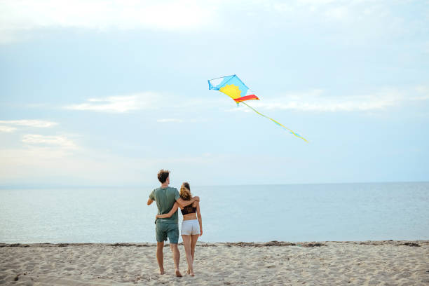 istock Playing with kite on beach near sea 1905665598
