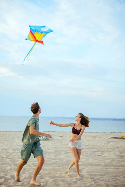istock Playing with kite on beach near sea 1905666623