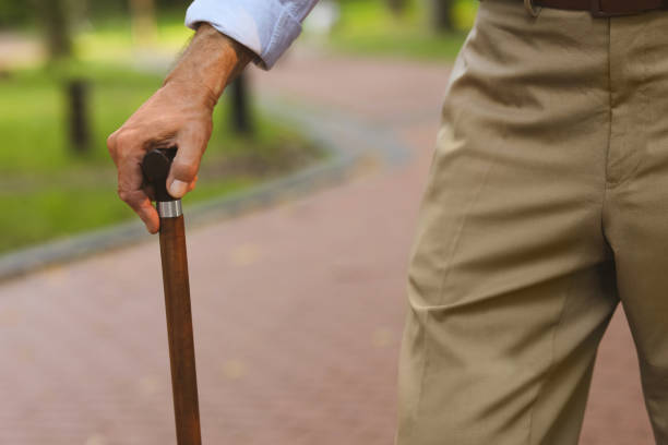 istock Senior man with walking cane outdoors, closeup 1905690752
