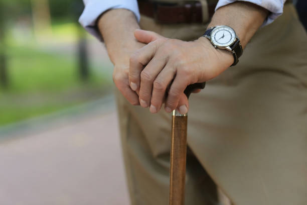 istock Senior man with walking cane outdoors, closeup 1905691257