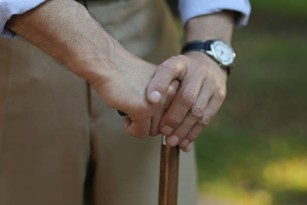 istock Senior man with walking cane outdoors, closeup 1905691258