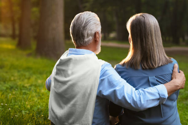 istock Affectionate senior couple spending time together in park, back view. Romantic date 1905696501