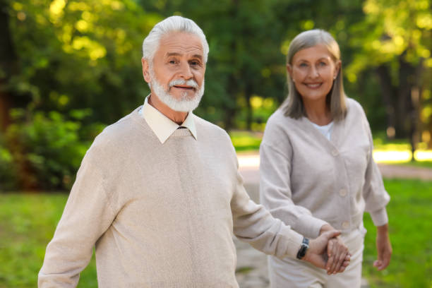 istock Affectionate senior couple spending time together in park, selective focus. Romantic date 1905696508