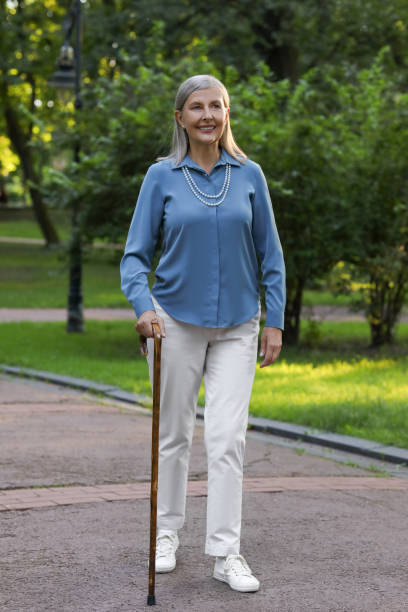 Senior woman with walking cane in park