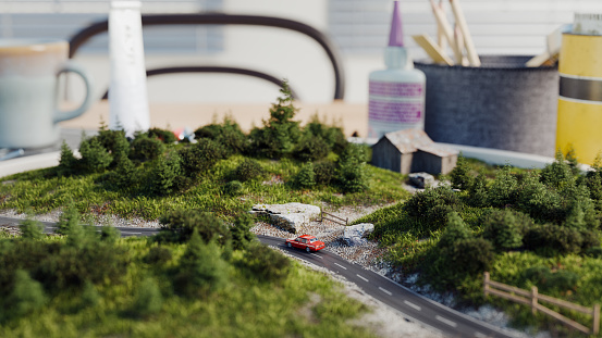 Miniature scene of a car on a rural road, diorama