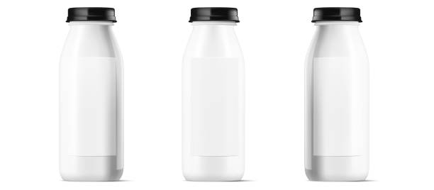 istock et of three sleek white bottles with black caps, versatile for milk, cream, or dessert drinks. Isolated vector illustration, front view with blank label for design mockup. Vector illustration. 1905718331